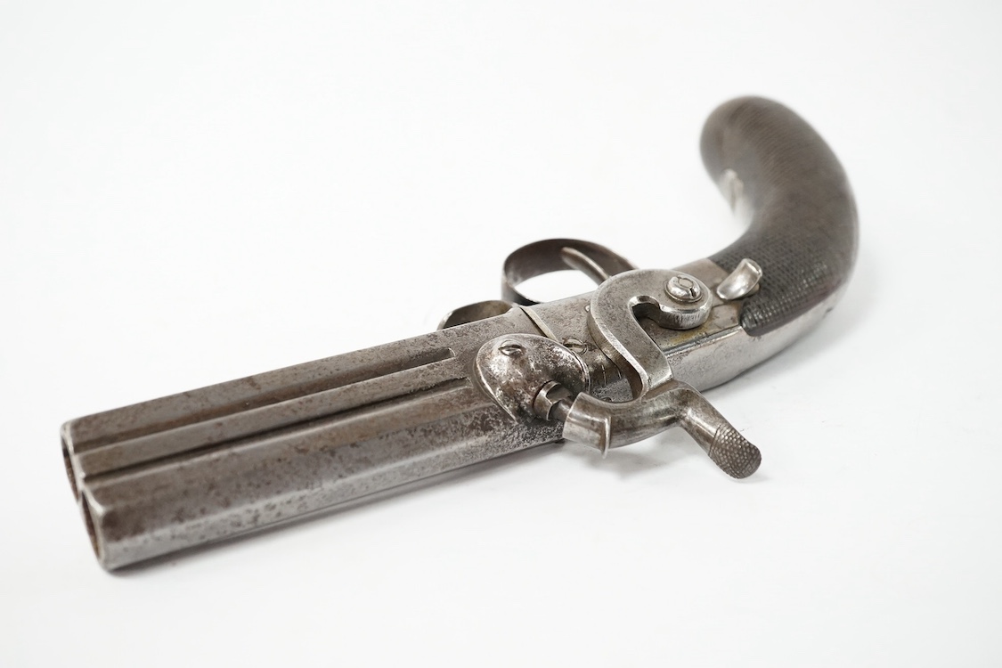 A two shot 34 bore turnover percussion travelling pistol, barrel with London and Birmingham proof marks, 9.5 cm, unsigned, sliding thumb safety catch, boxlock side hammer action, rounded chequered walnut grip with oval n